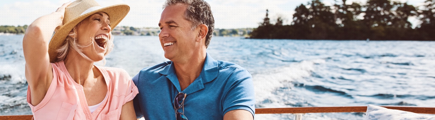 Couple laughing while riding a boat