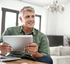 Mature man holding Tablet